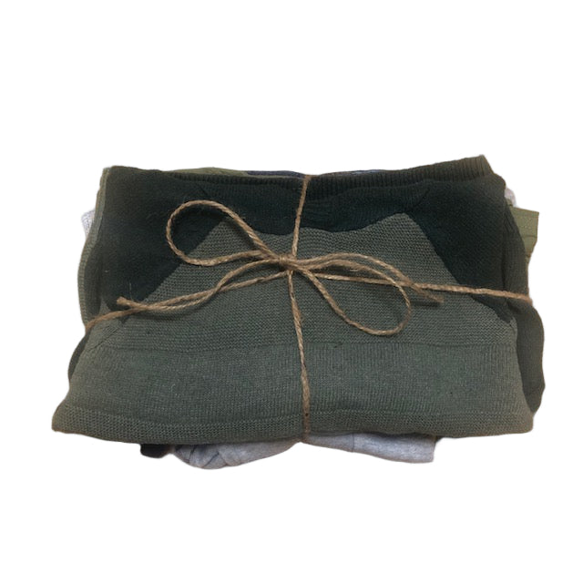Folded green fabric with twine on a wooden surface
